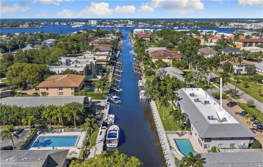 1686 Blue Point Avenue, Unit B7 Naples, FL 34102 - Photo 5 of 49 an aerial view of residential houses with outdoor space and swimming pool