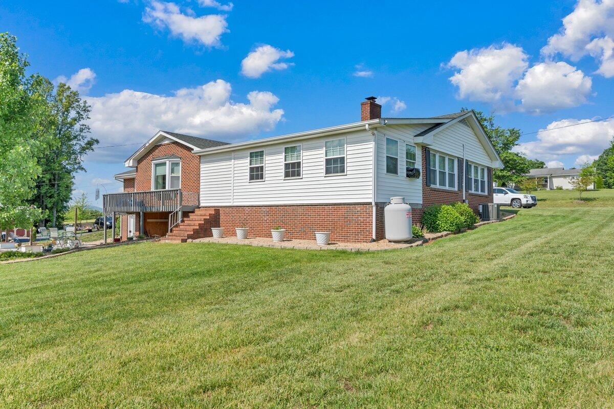 3226 Rakes Road Rocky Mount, VA 24151 - Photo 67 of 74 a front view of a house with a yard and garage