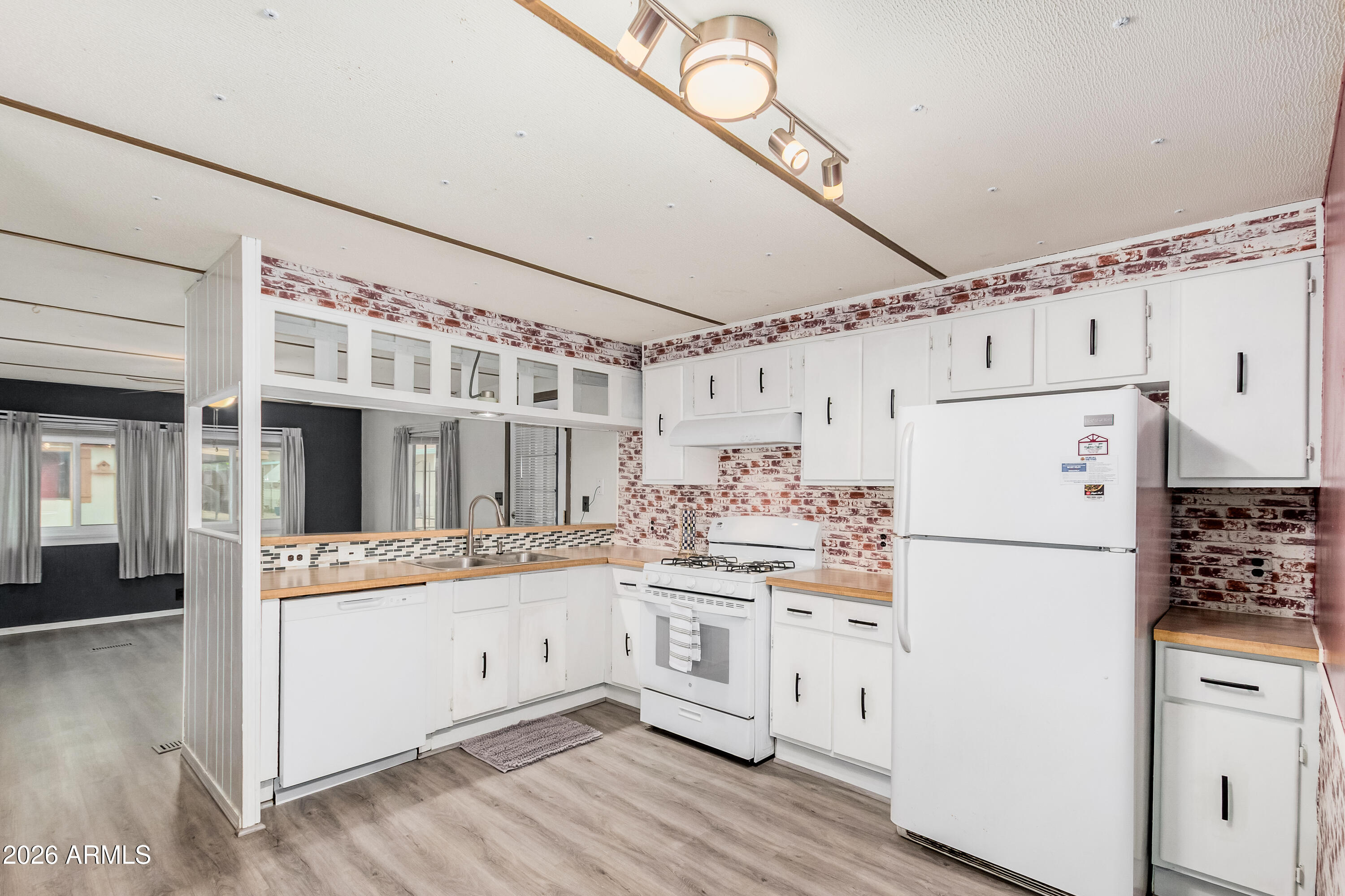 9302 East Broadway Road, Unit 122 Mesa, AZ 85208 - Photo 11 of 30 a white refrigerator freezer sitting inside of a kitchen