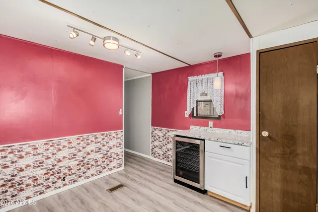 a kitchen with granite countertop a stove and cabinets