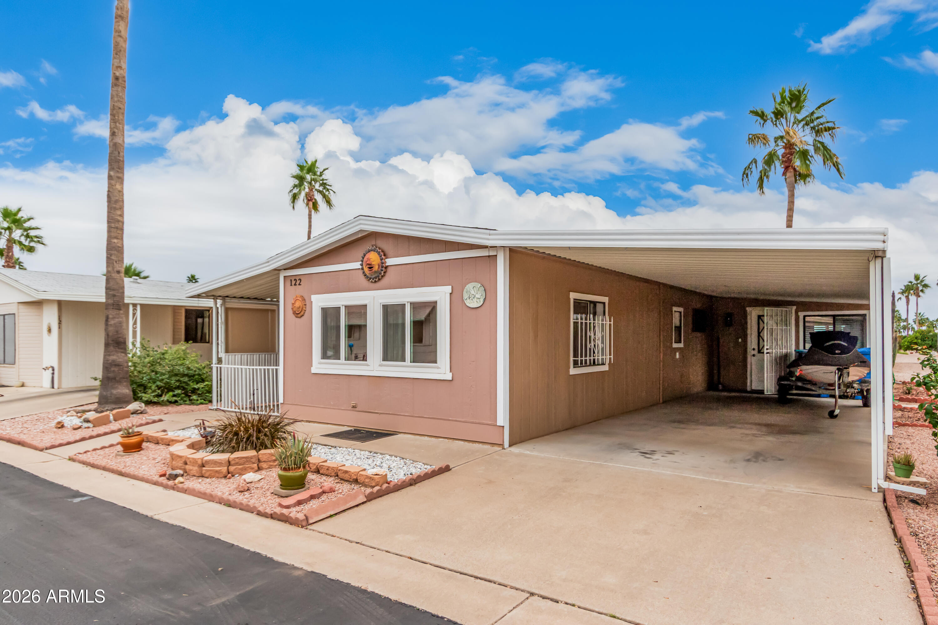 9302 East Broadway Road, Unit 122 Mesa, AZ 85208 - Photo 2 of 30 a front view of a house with a garden