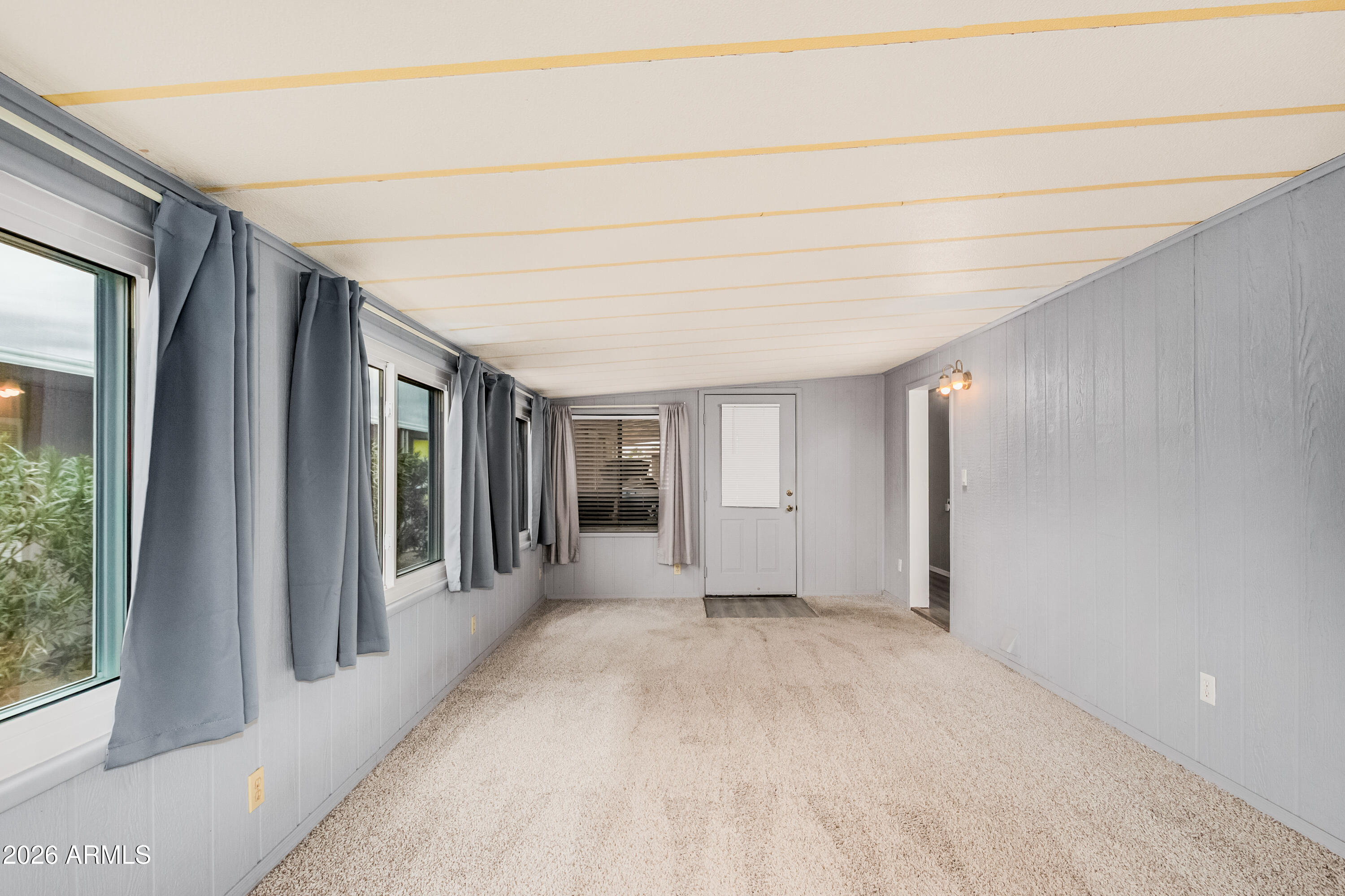 9302 East Broadway Road, Unit 122 Mesa, AZ 85208 - Photo 25 of 30 a view of a hallway with wooden shelves