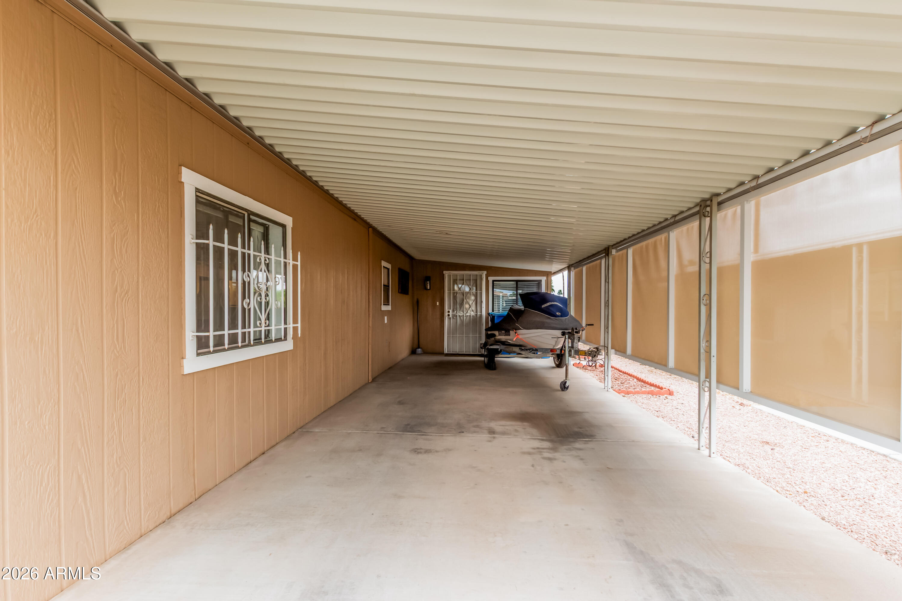 9302 East Broadway Road, Unit 122 Mesa, AZ 85208 - Photo 28 of 30 a view of a house with porch and parking area