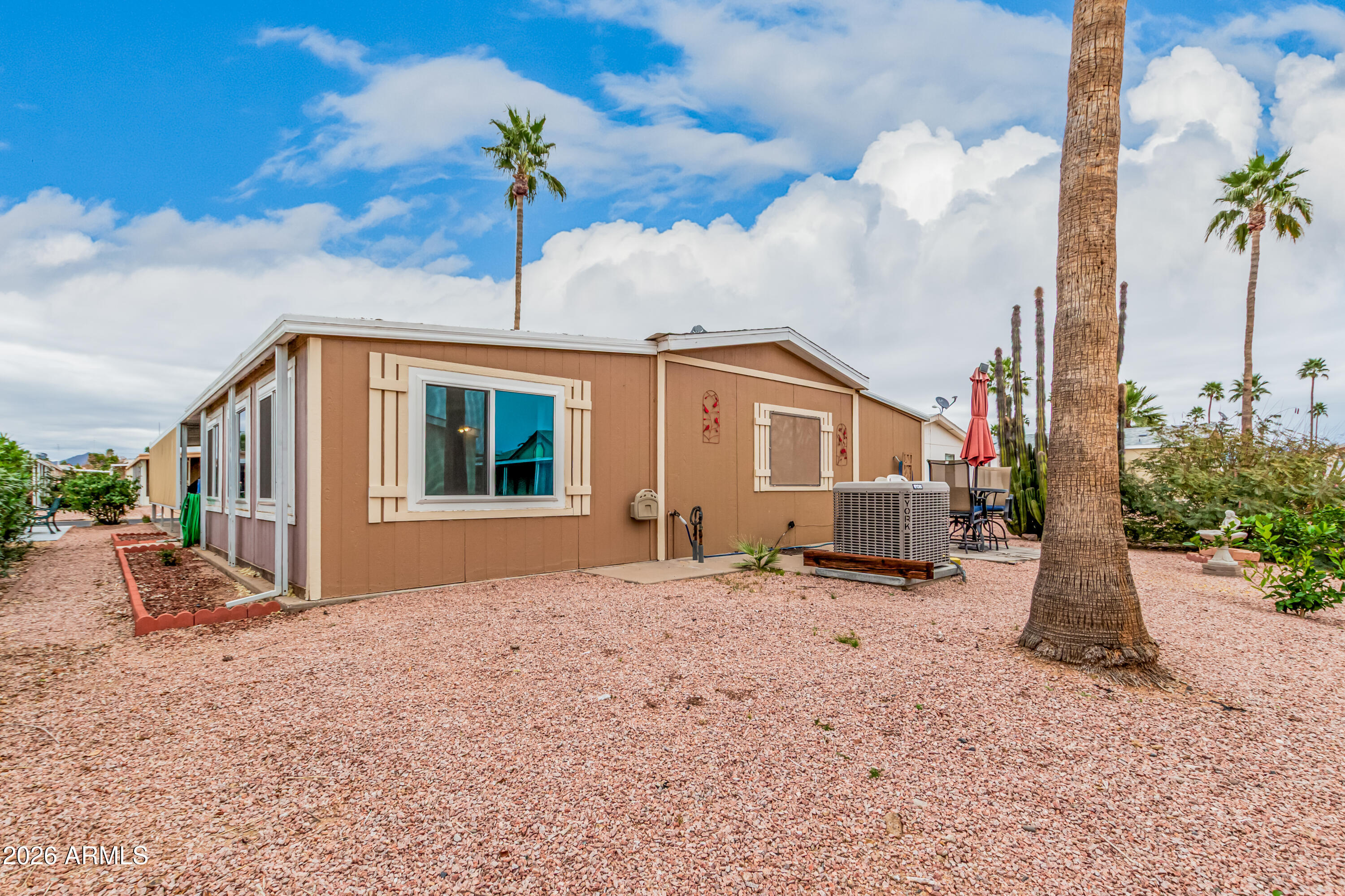 9302 East Broadway Road, Unit 122 Mesa, AZ 85208 - Photo 30 of 30 a front view of a house with a garden and trees