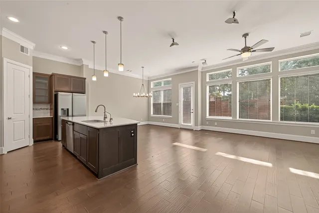 a kitchen with stainless steel appliances granite countertop a sink a oven and a large window with outer view