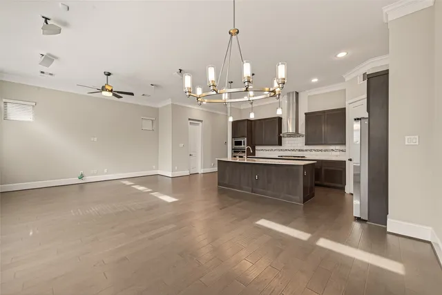 a large kitchen with kitchen island a sink stainless steel appliances and cabinets