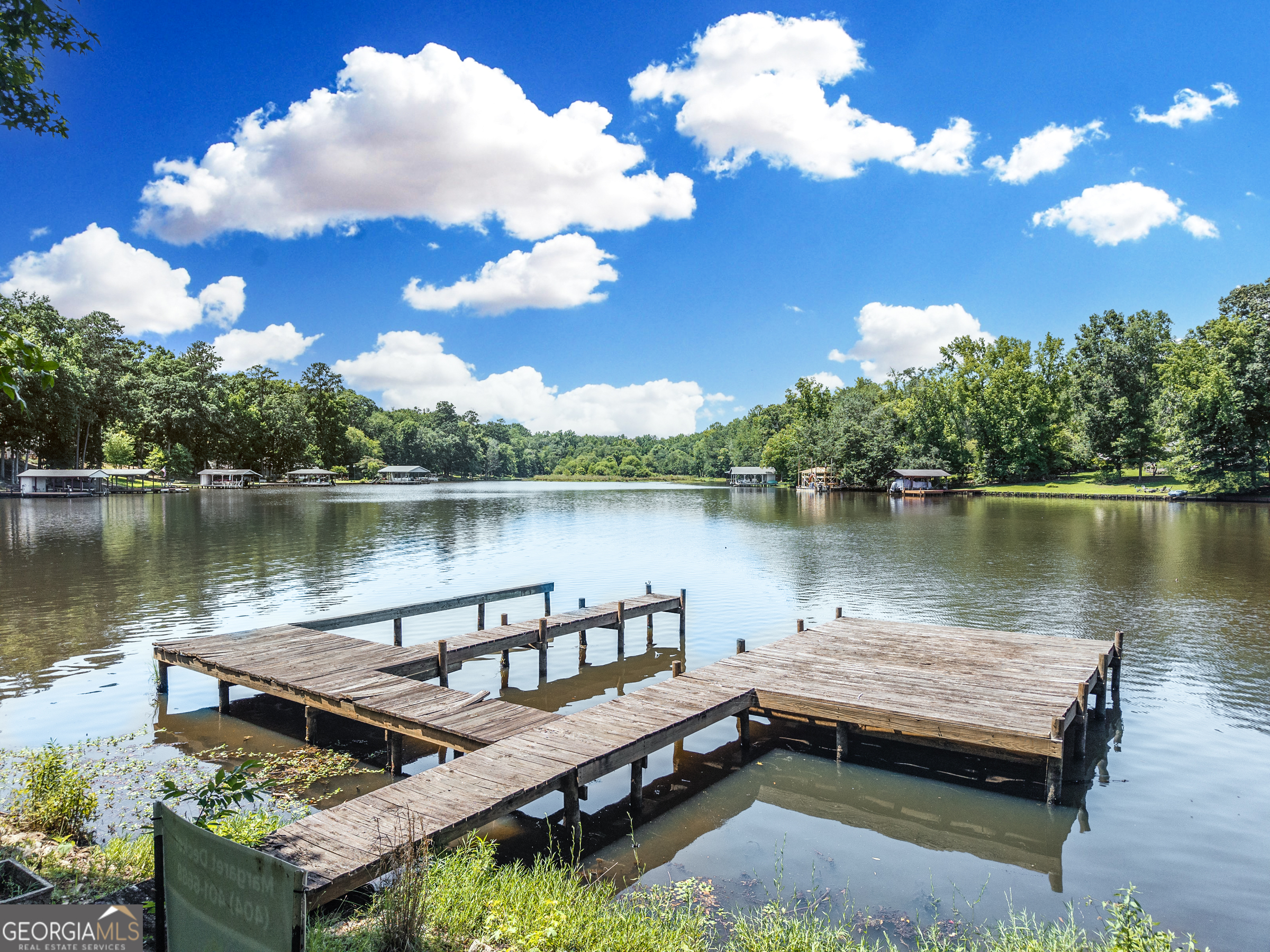 909 South Steel Bridge Road Eatonton, GA 31024 - Photo 12 of 18 a view of a lake with couches chairs