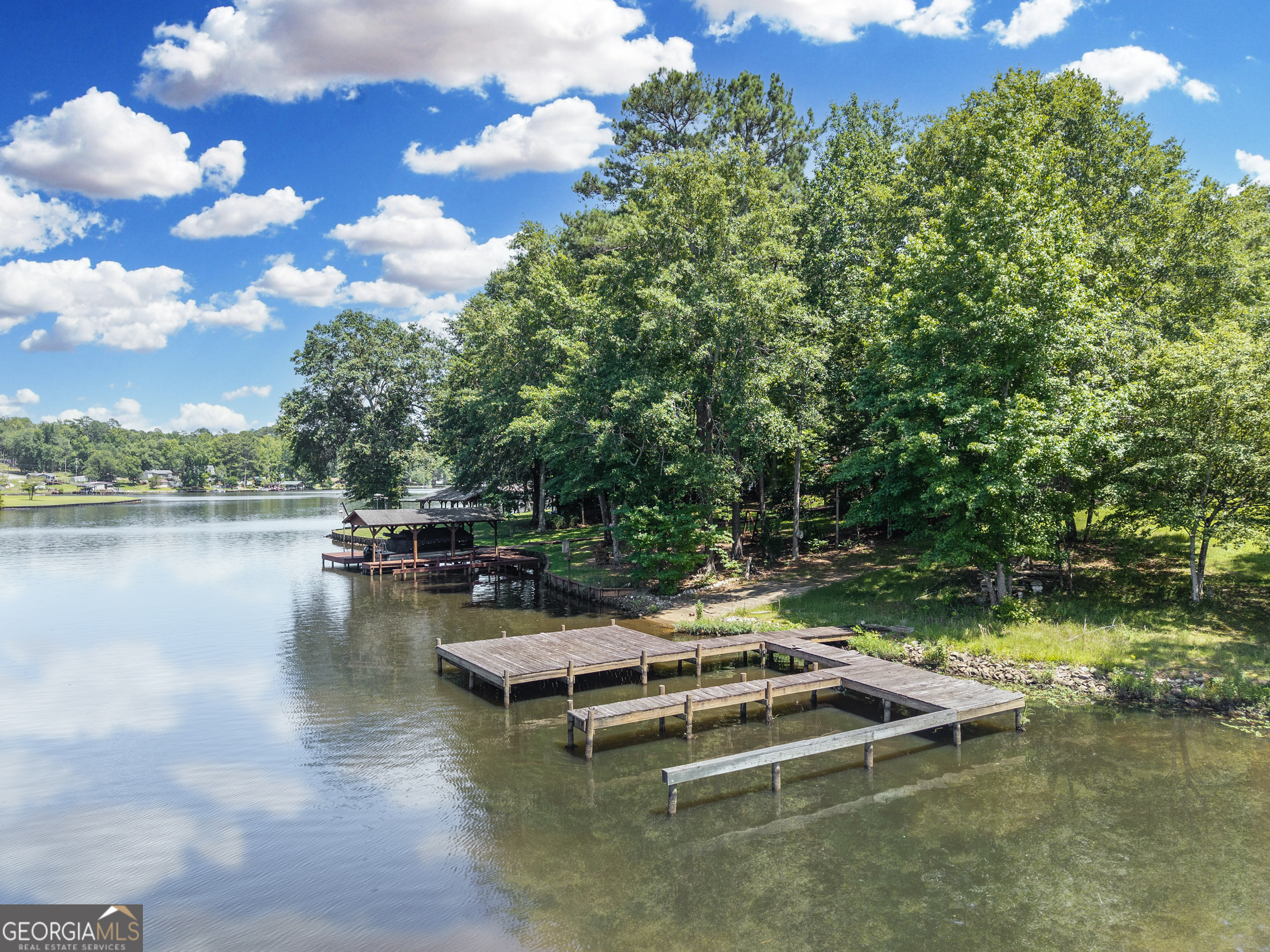 909 South Steel Bridge Road Eatonton, GA 31024 - Photo 13 of 18 a view of a lake with lawn chairs