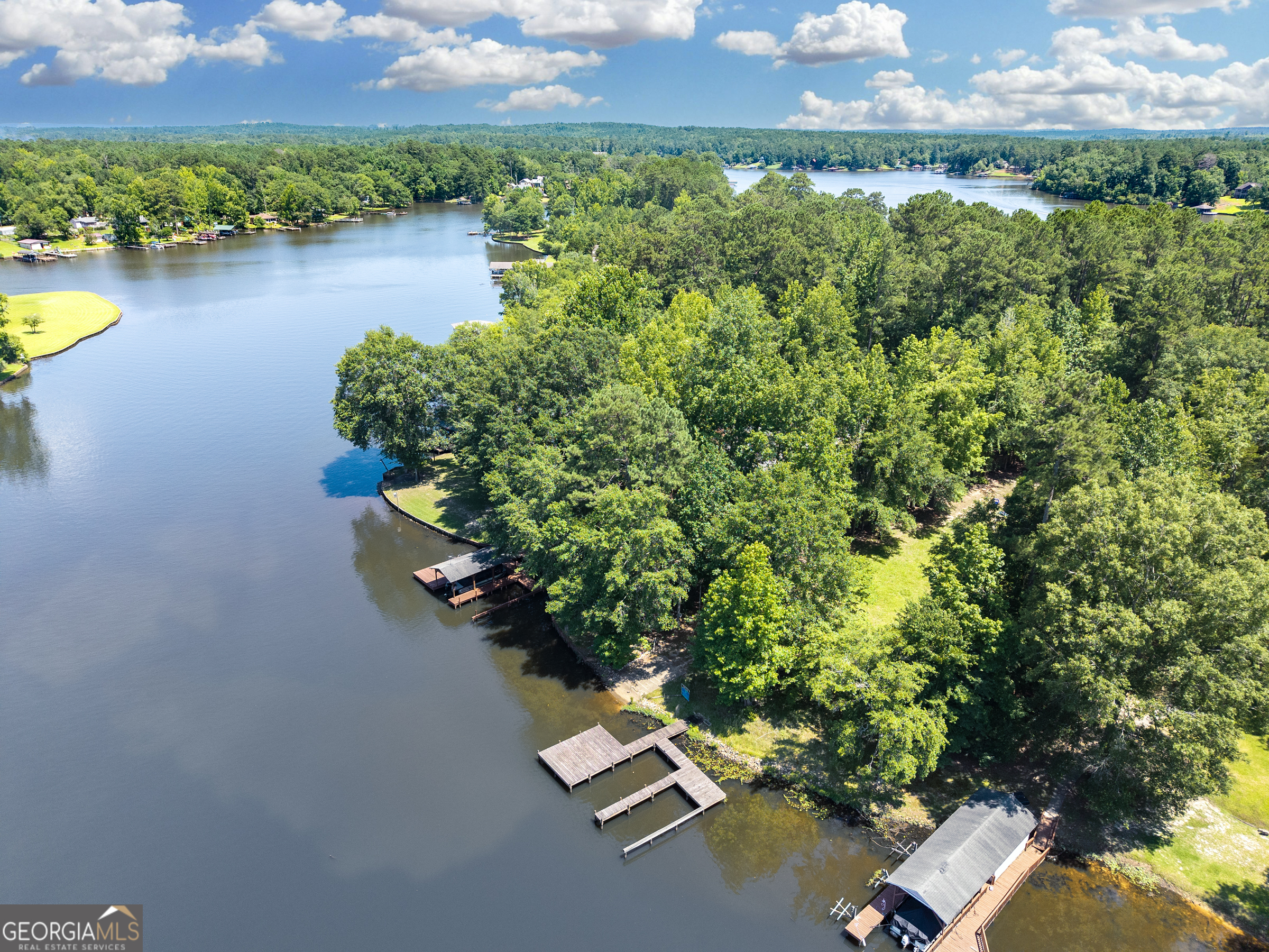 909 South Steel Bridge Road Eatonton, GA 31024 - Photo 3 of 18 an aerial view of a house with a yard and lake view
