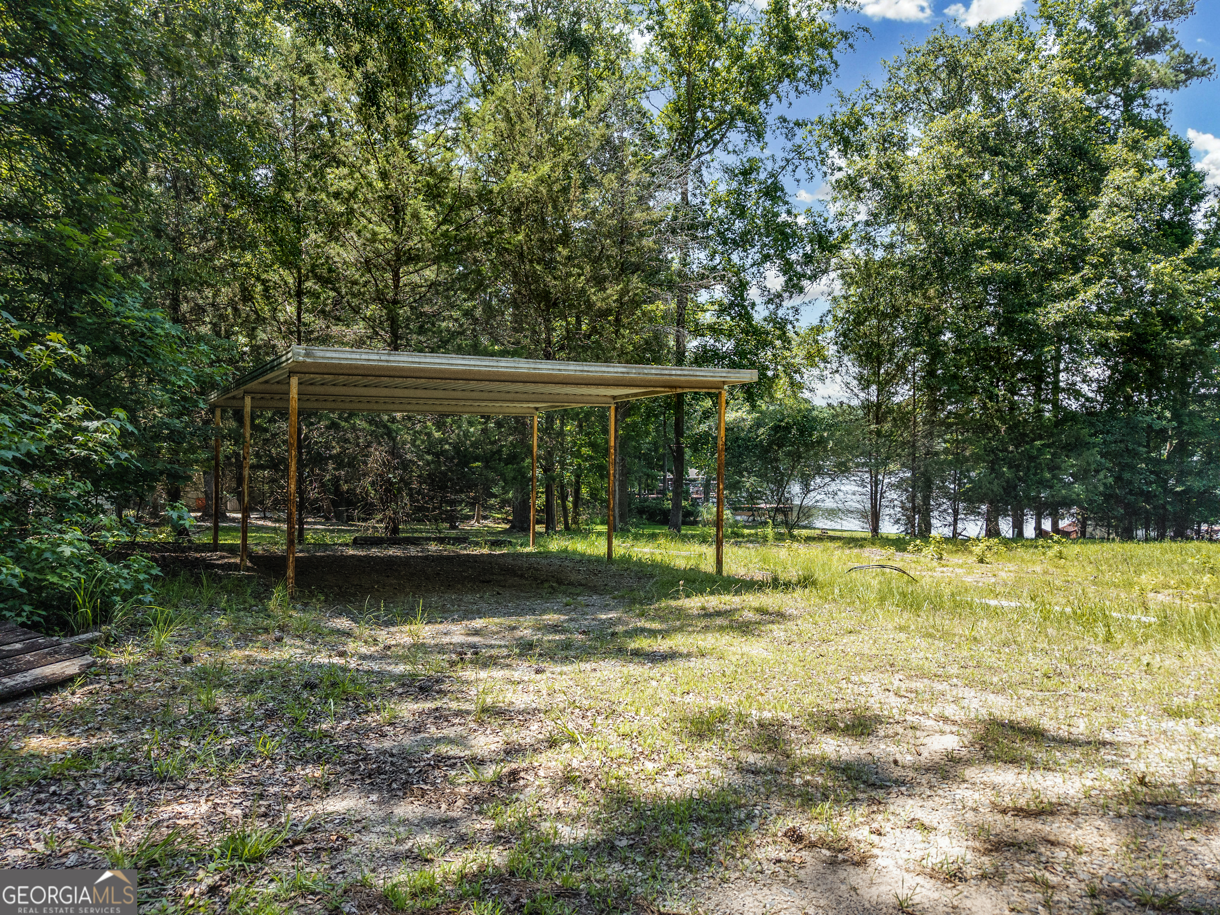 909 South Steel Bridge Road Eatonton, GA 31024 - Photo 8 of 18 a view of a house with a yard balcony and sitting area