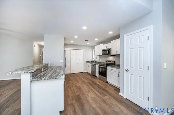 a kitchen with a sink stainless steel appliances and cabinets