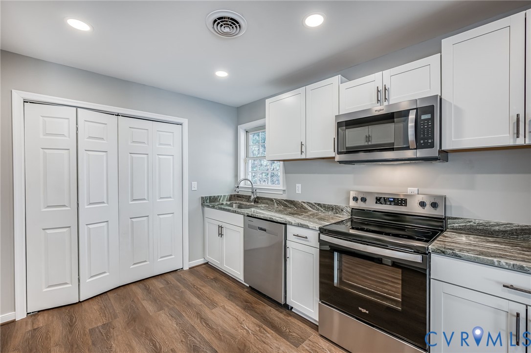 16702 South Crater Road Petersburg, VA 23805 - Photo 13 of 29 a kitchen with granite countertop cabinets stainless steel appliances and wooden floor