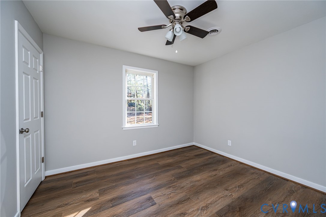 16702 South Crater Road Petersburg, VA 23805 - Photo 21 of 29 an empty room with wooden floor fan and windows