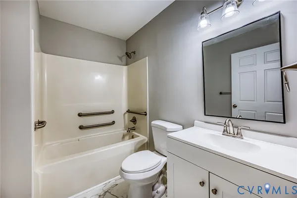 a bathroom with a sink toilet vanity and shower