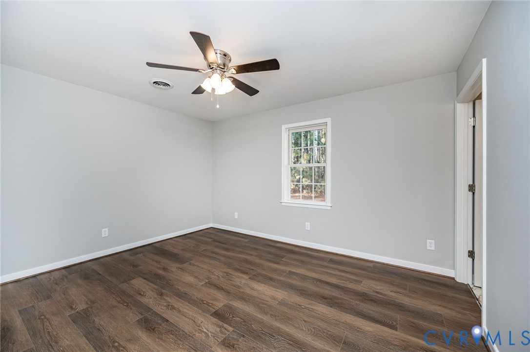 16702 South Crater Road Petersburg, VA 23805 - Photo 24 of 29 an empty room with wooden floor fan and windows