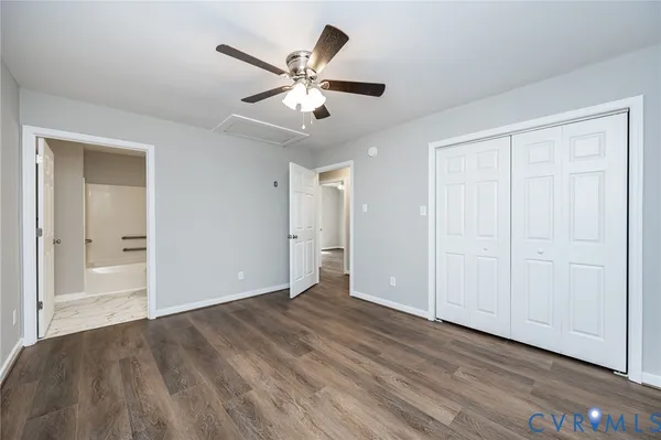a view of an empty room with wooden floor