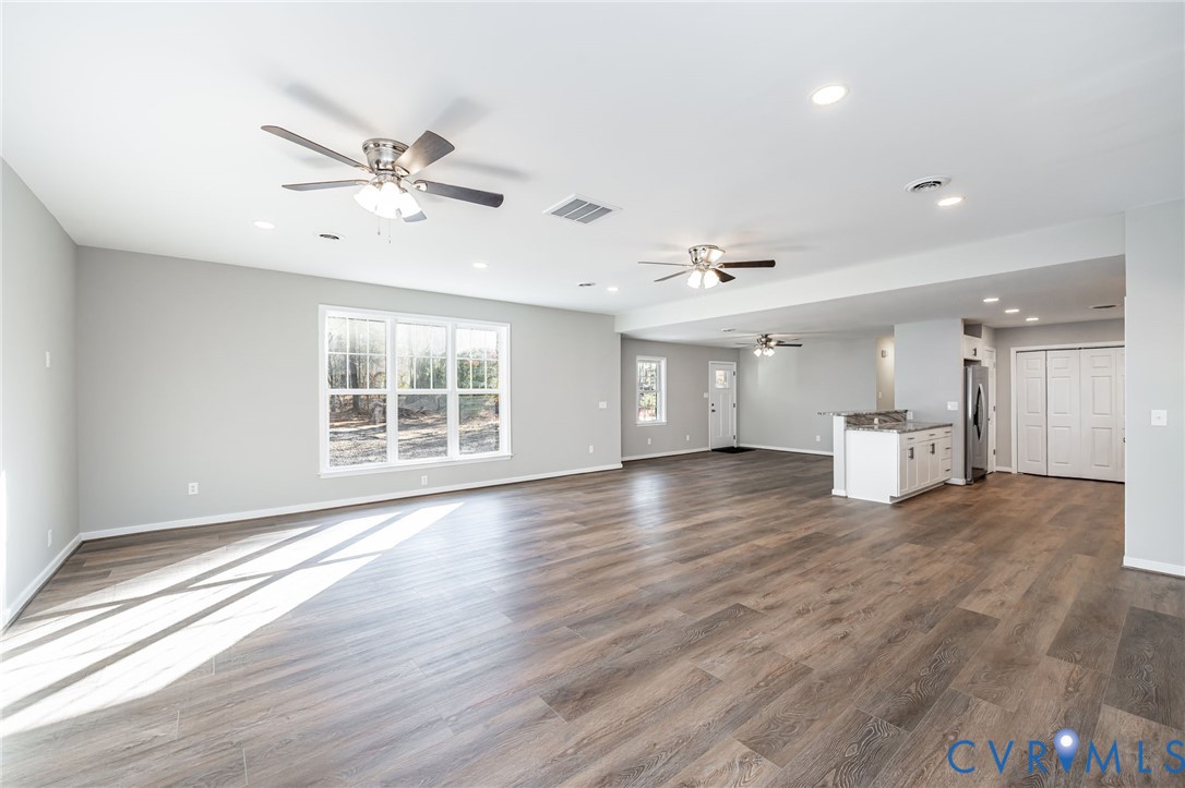 16702 South Crater Road Petersburg, VA 23805 - Photo 7 of 29 a view of an empty room with a window and wooden floor