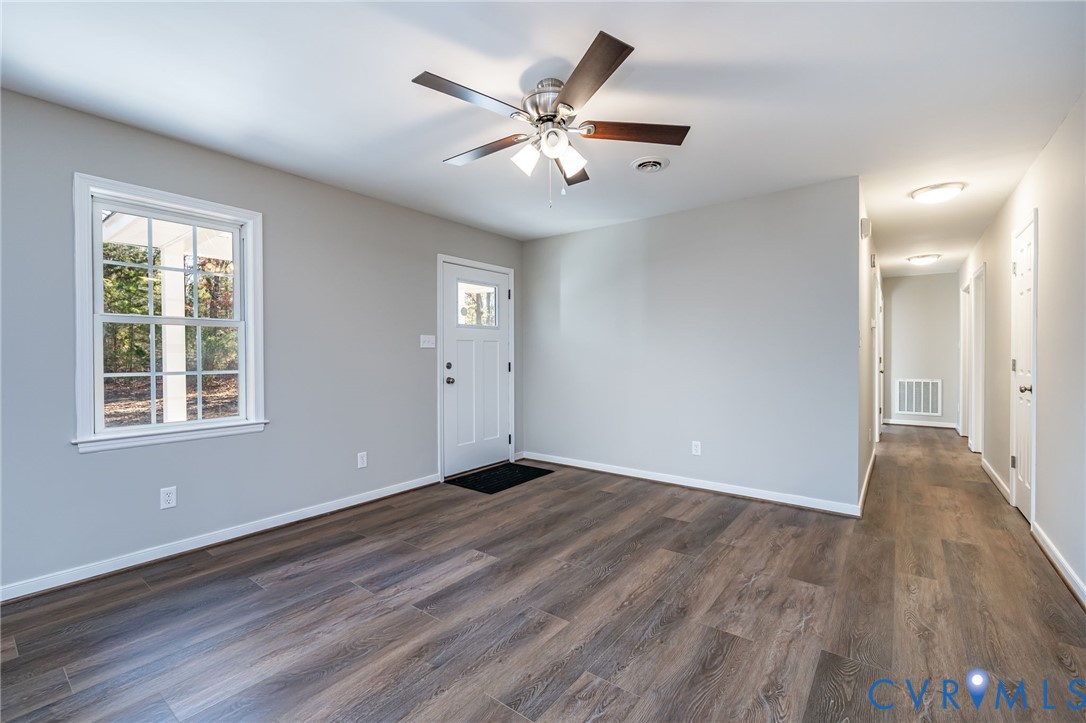 16702 South Crater Road Petersburg, VA 23805 - Photo 8 of 29 a view of an empty room with wooden floor and a window