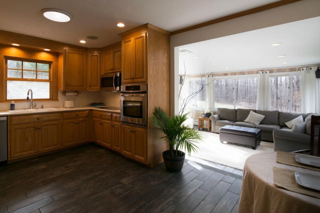 a kitchen with a sink dishwasher a stove and a refrigerator with wooden floor