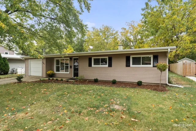 a backyard of a house with yard table and chairs