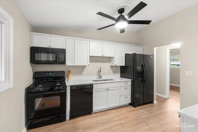 a kitchen with a stove a refrigerator and a sink