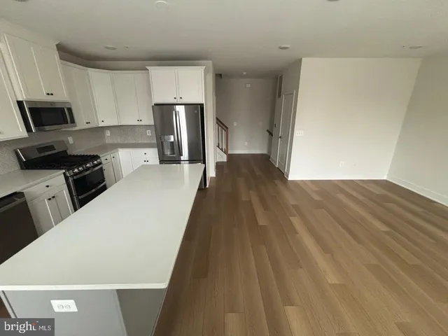 a kitchen with a refrigerator a stove top oven a sink and dishwasher