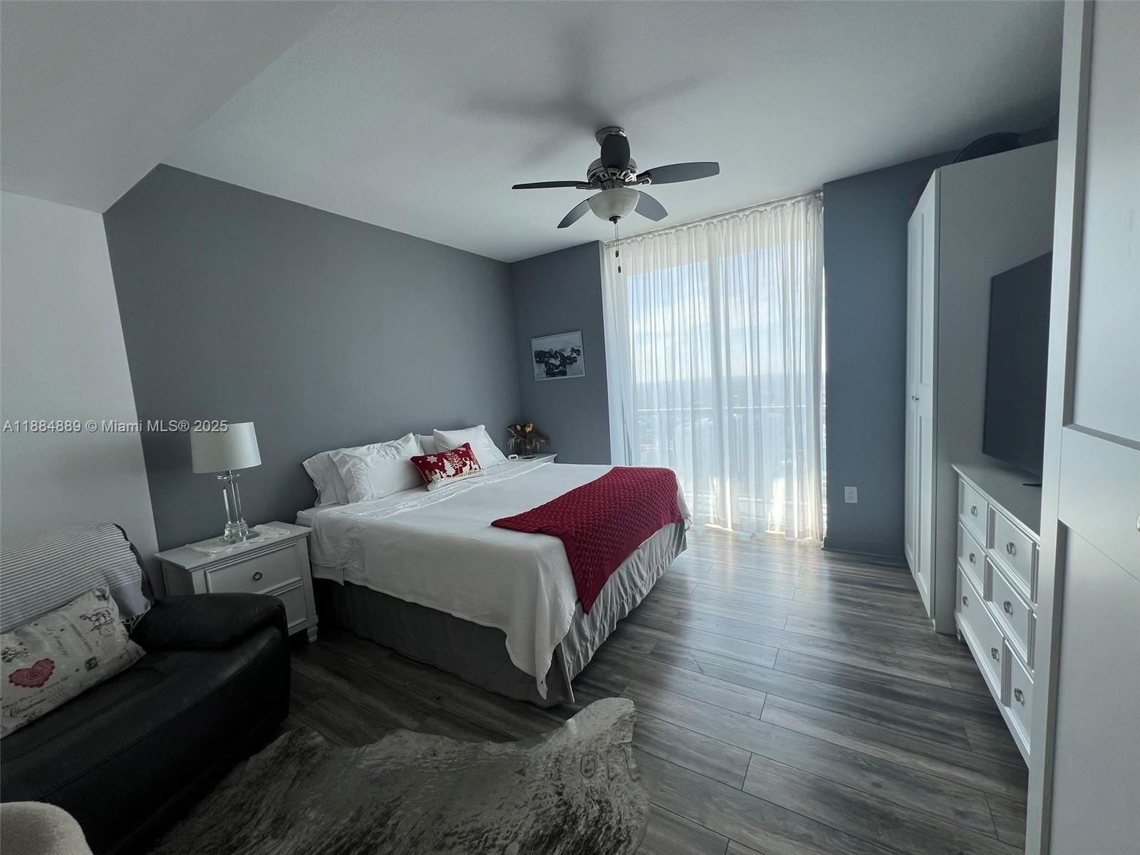 1111 Southwest 1st Avenue, Unit 3225 Miami, FL 33130 - Photo 7 of 24 a bed room with a bed window and a wooden floor