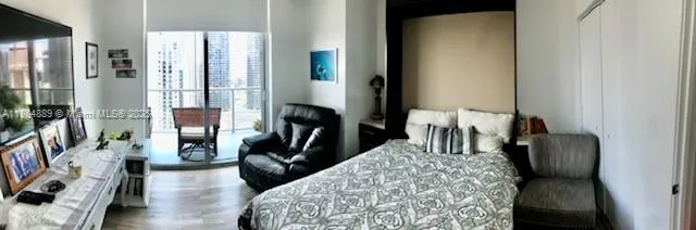 a bedroom with furniture and a flat tv screen