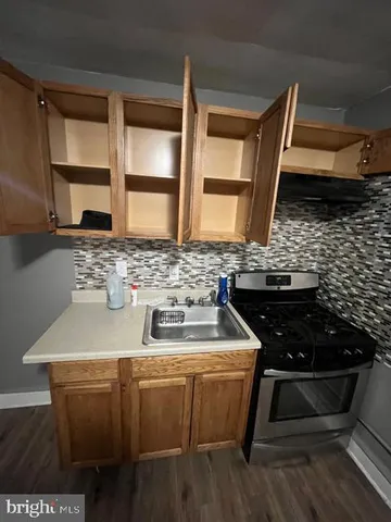 a kitchen with a sink and a stove top oven