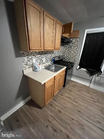 a kitchen with stainless steel appliances a sink and cabinets