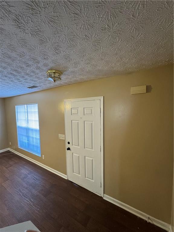 5869 Strathmoor Manor Circle Lithonia, GA 30058 - Photo 1 of 13 an empty room with wooden floor and windows