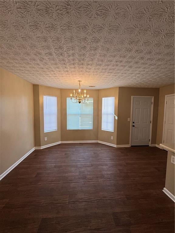 5869 Strathmoor Manor Circle Lithonia, GA 30058 - Photo 11 of 13 an empty room with wooden floor and windows