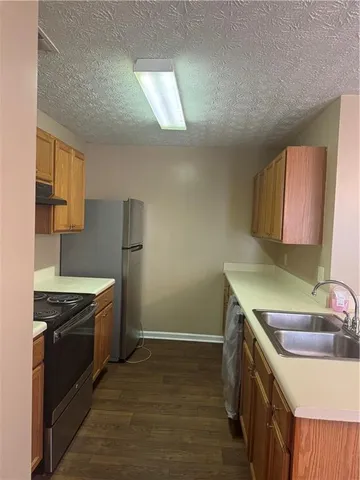 a kitchen that has a sink and a stove