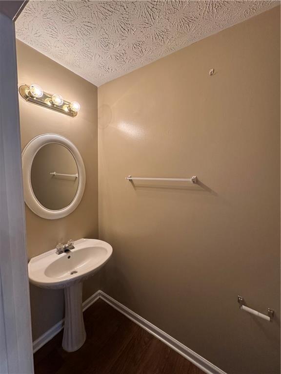5869 Strathmoor Manor Circle Lithonia, GA 30058 - Photo 12 of 13 a bathroom with a sink a mirror and a toilet