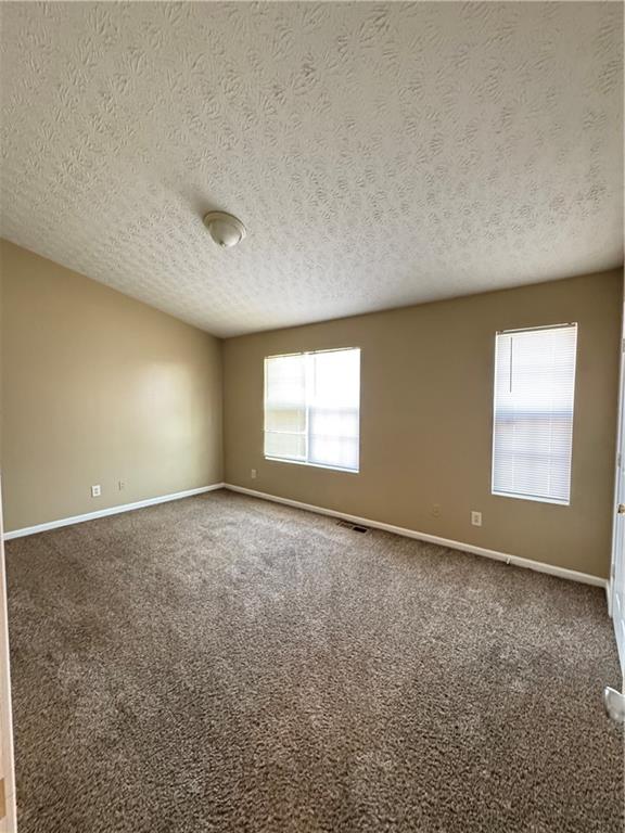 5869 Strathmoor Manor Circle Lithonia, GA 30058 - Photo 3 of 13 an empty room with windows