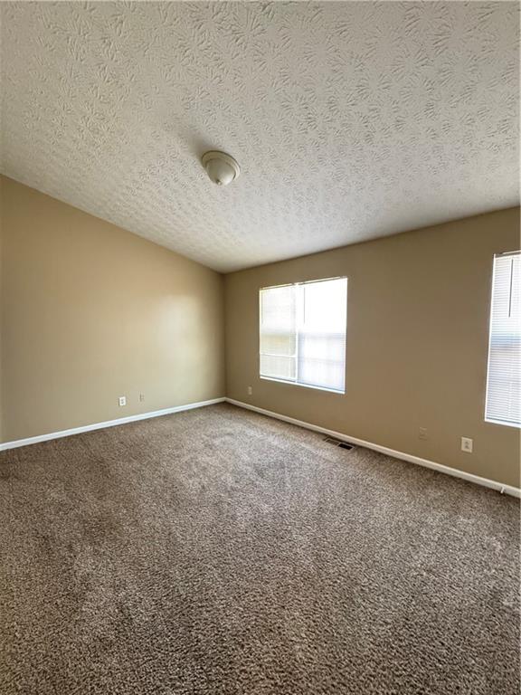 5869 Strathmoor Manor Circle Lithonia, GA 30058 - Photo 4 of 13 an empty room with a empty space and window