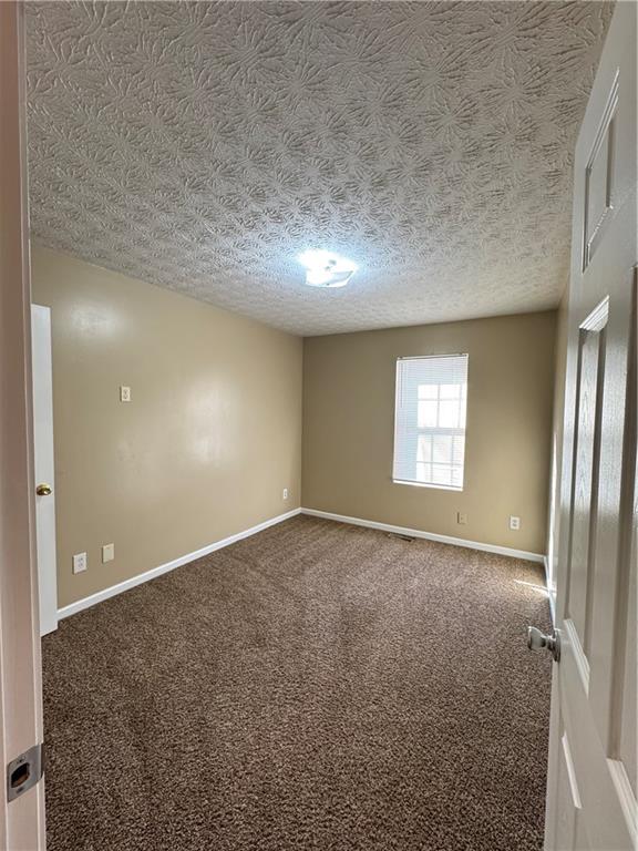 5869 Strathmoor Manor Circle Lithonia, GA 30058 - Photo 5 of 13 an empty room with windows and closet