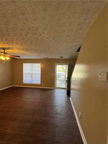 a view of a room with wooden floor and window