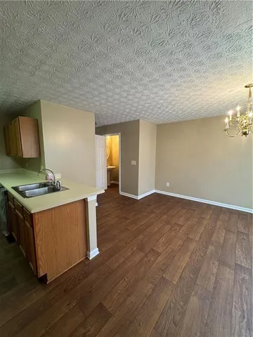 a view of kitchen and wooden floor