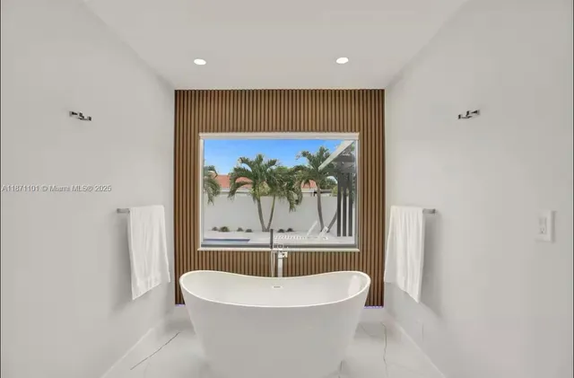 a bedroom with a bed and a view of kitchen