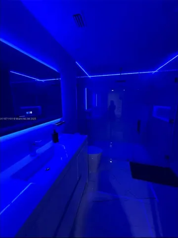 a living room with two couches and a potted plant on coffee table with wooden floor