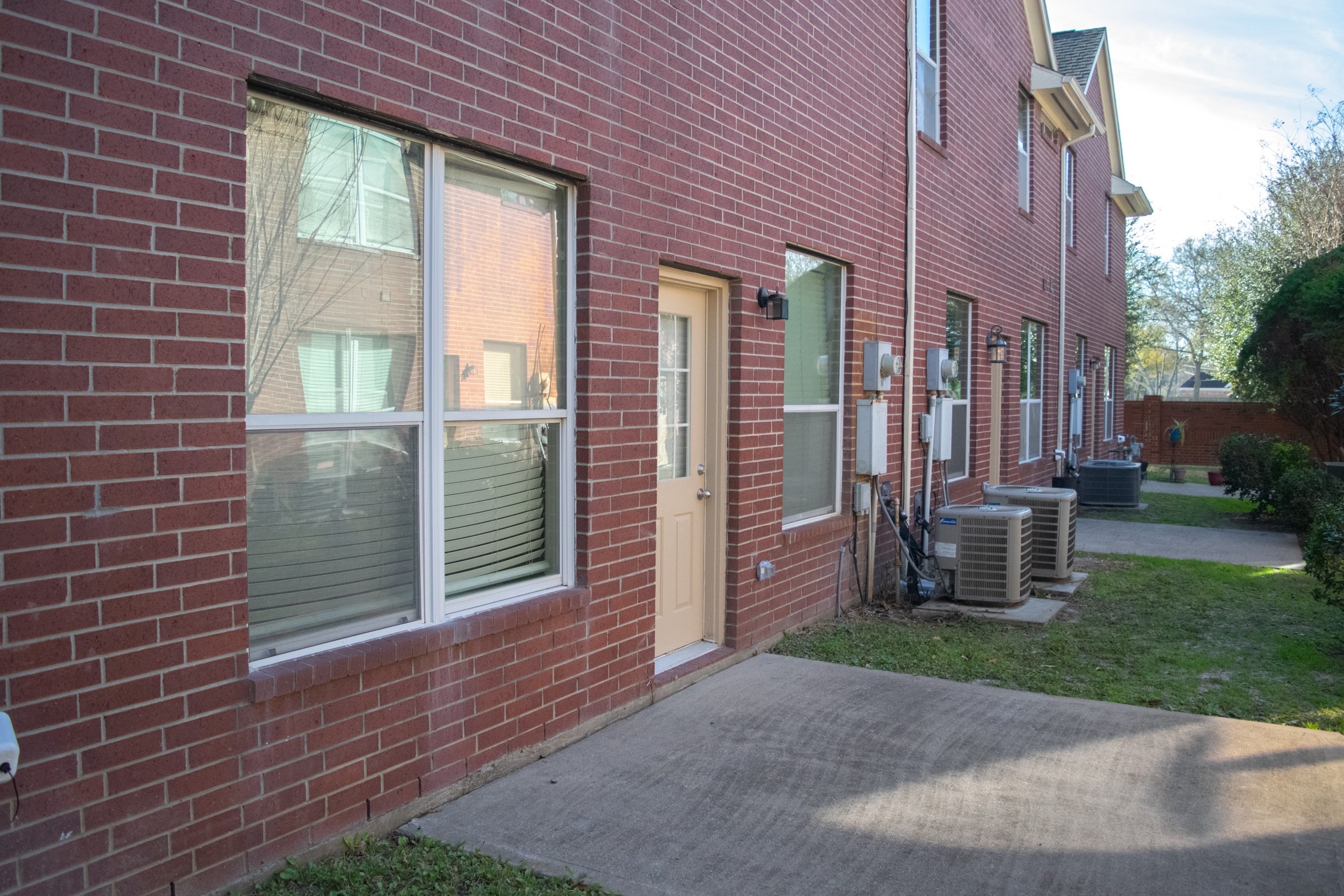 9224 Rodney Ray Boulevard, Unit 18 Houston, TX 77040 - Photo 13 of 27 a view of a brick house with a yard