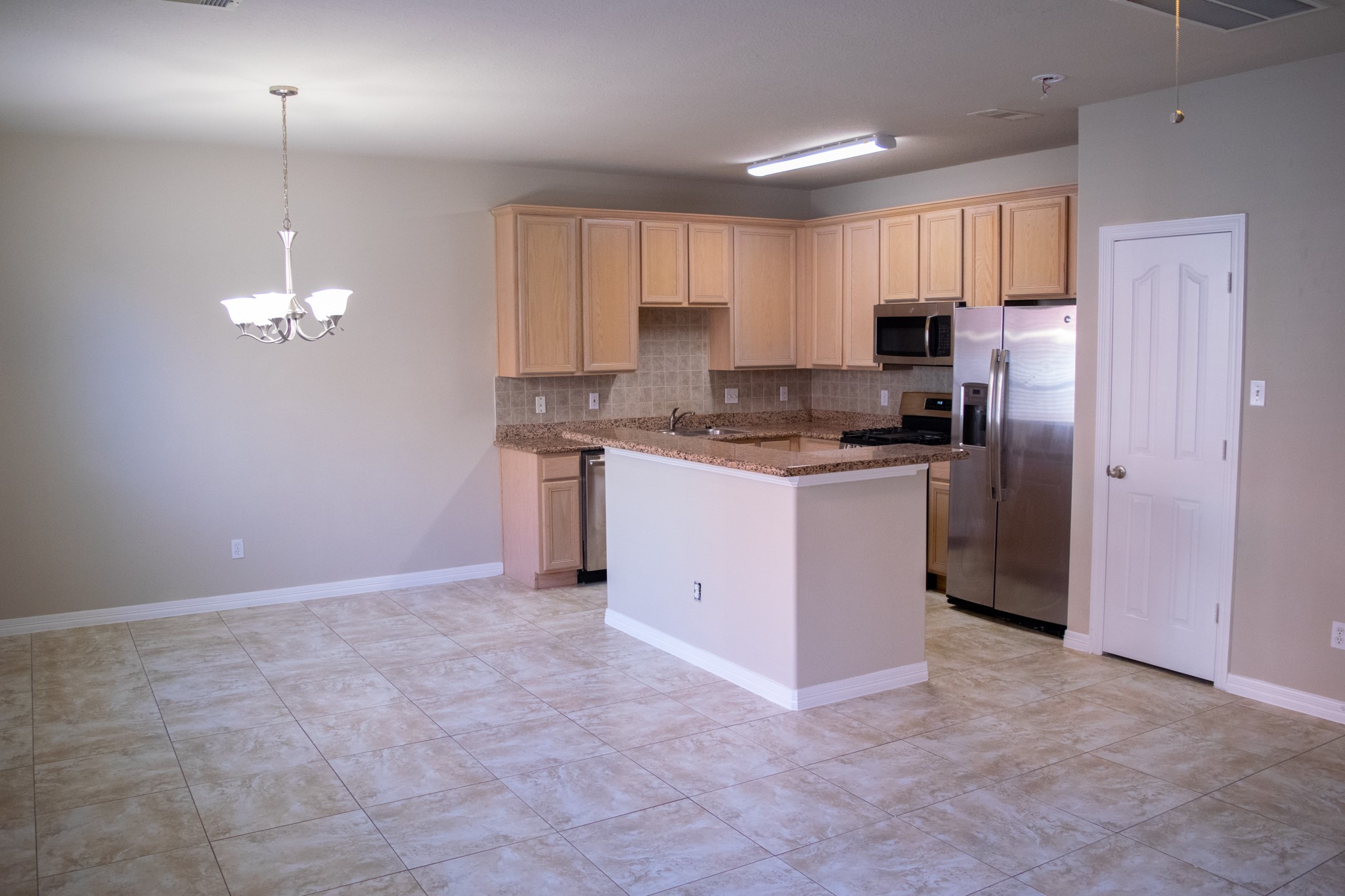 9224 Rodney Ray Boulevard, Unit 18 Houston, TX 77040 - Photo 15 of 27 a kitchen with stainless steel appliances a refrigerator sink and cabinets