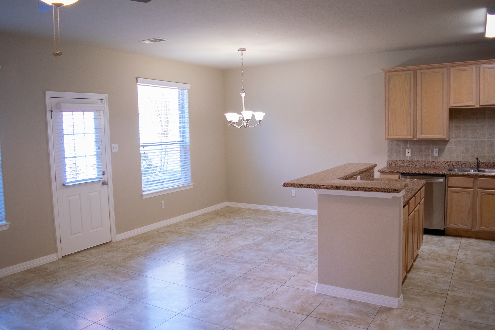 9224 Rodney Ray Boulevard, Unit 18 Houston, TX 77040 - Photo 16 of 27 a kitchen with stainless steel appliances granite countertop a sink a stove a refrigerator and cabinets