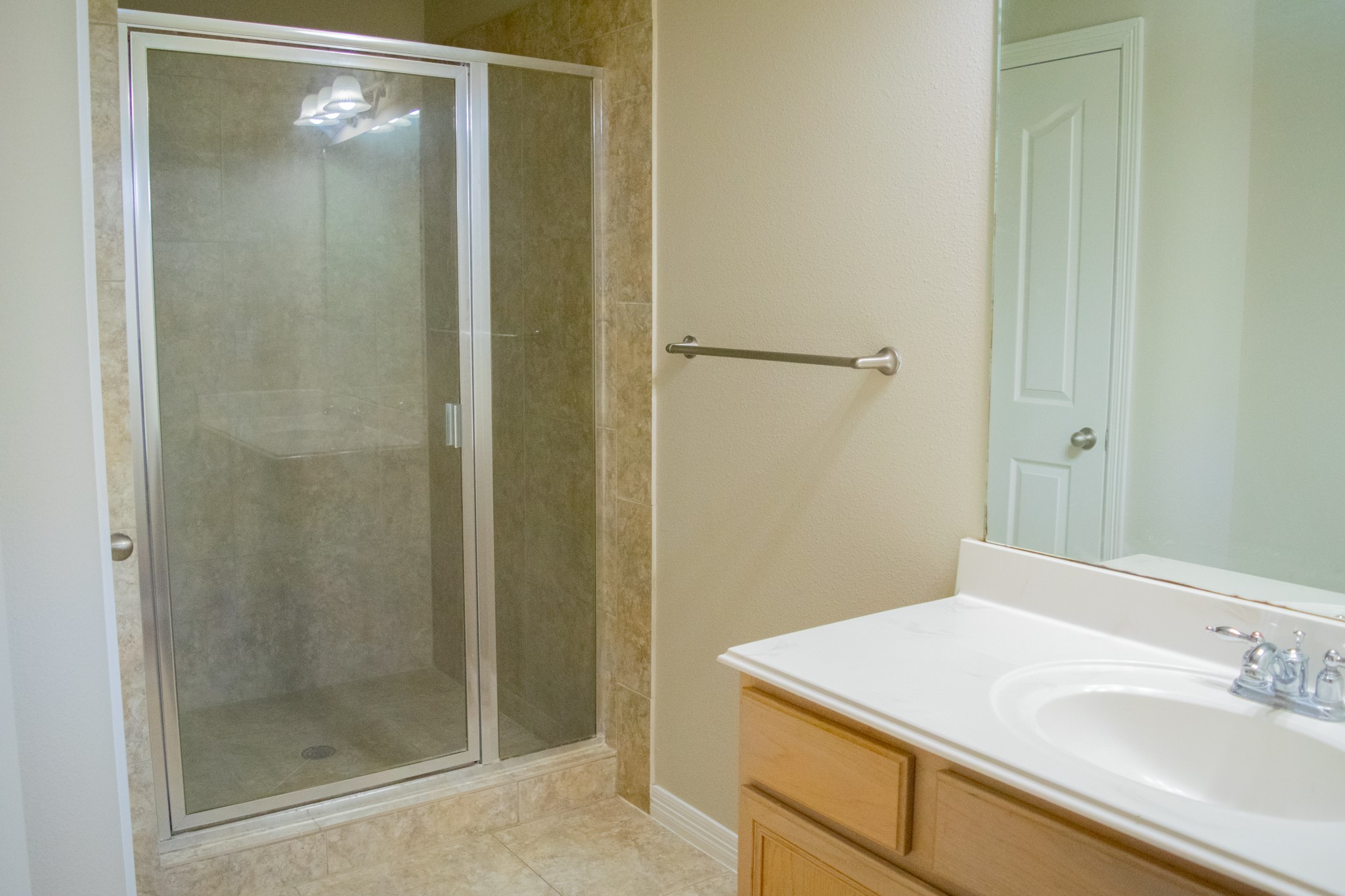 9224 Rodney Ray Boulevard, Unit 18 Houston, TX 77040 - Photo 24 of 27 a bathroom with a sink a shower and a mirror