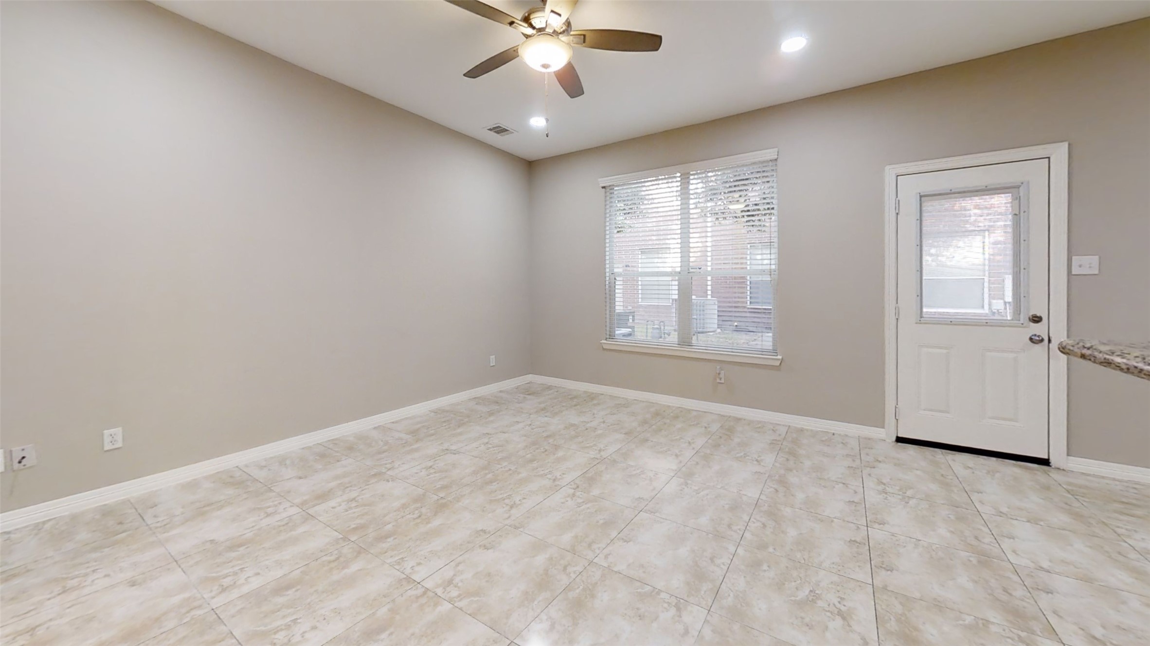 9224 Rodney Ray Boulevard, Unit 18 Houston, TX 77040 - Photo 10 of 27 an empty room with chandelier fan and windows