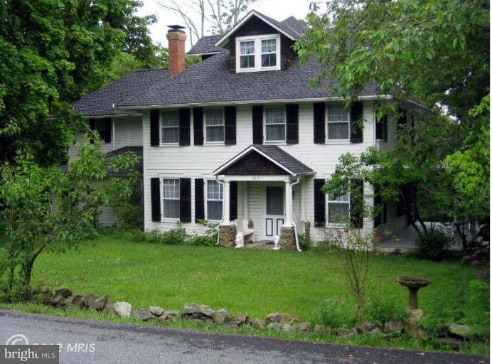 5815 Rowland Hill Road Cascade, MD 21719 - Photo 1 of 30 a front view of a house with garden and trees