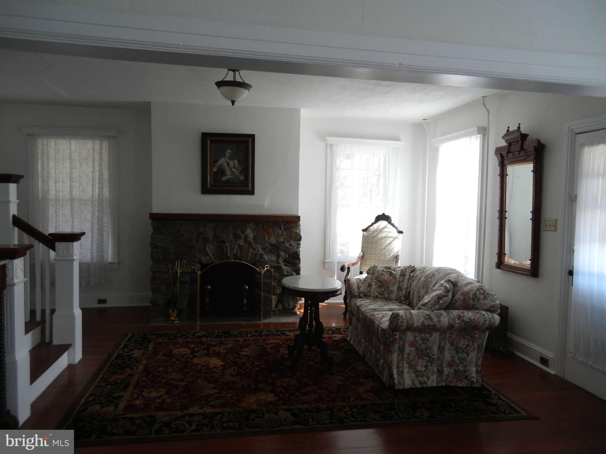 5815 Rowland Hill Road Cascade, MD 21719 - Photo 2 of 30 a living room with furniture and a fireplace