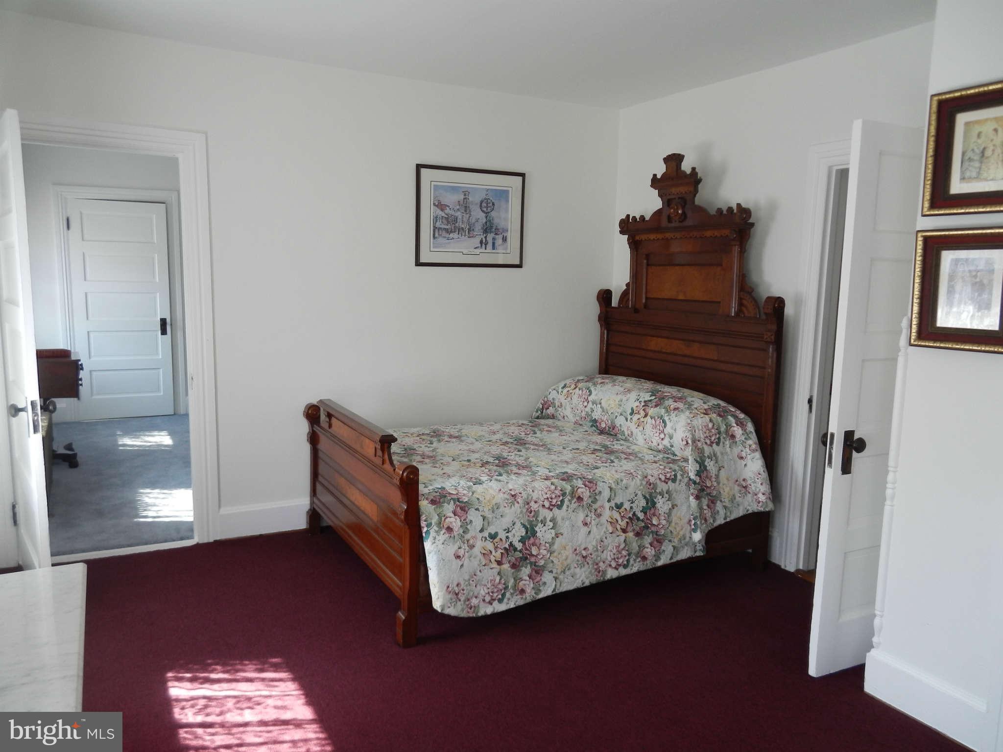 5815 Rowland Hill Road Cascade, MD 21719 - Photo 17 of 30 a bedroom with a bed and a chandelier
