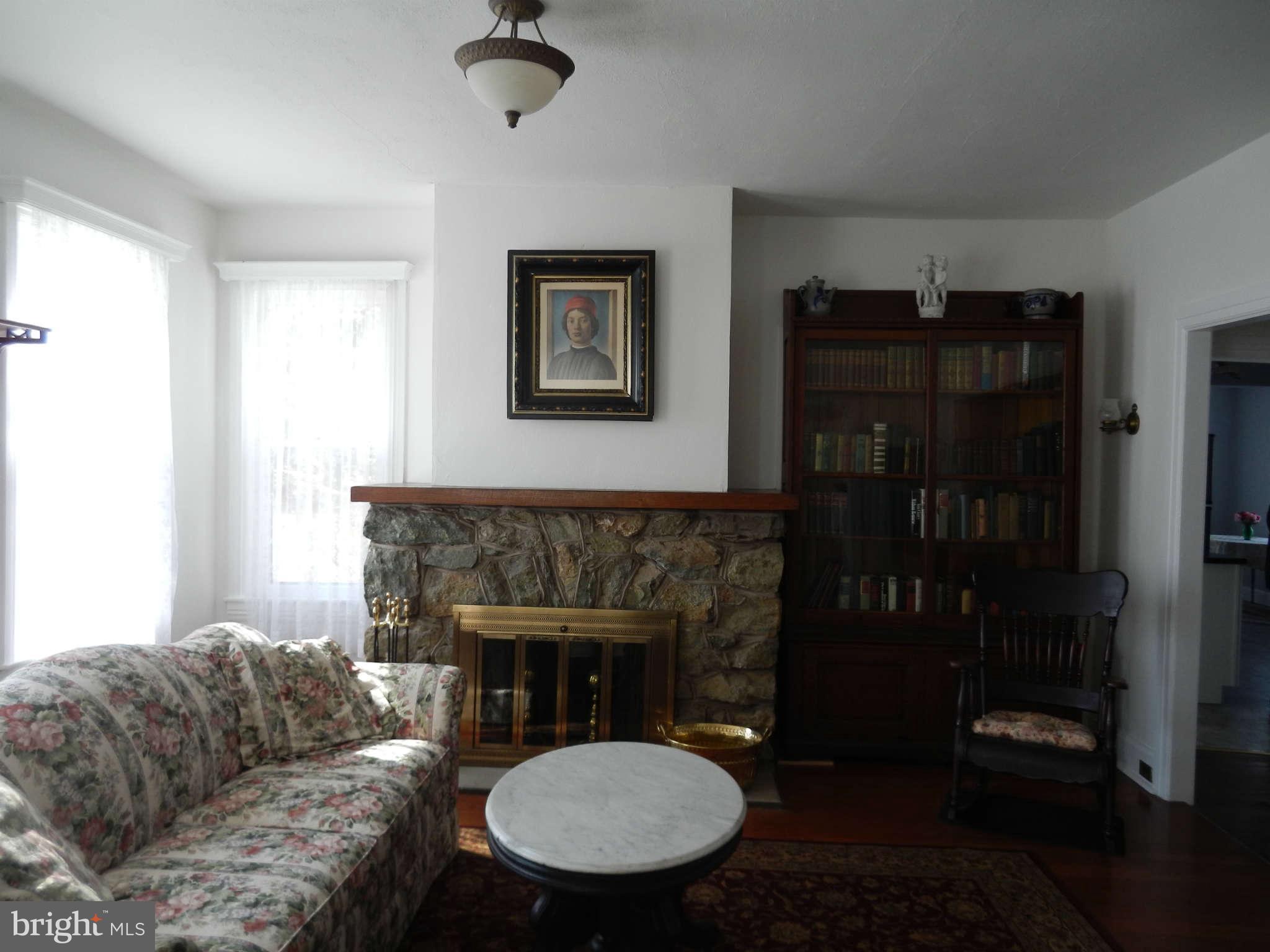 5815 Rowland Hill Road Cascade, MD 21719 - Photo 3 of 30 a living room with furniture a table and a fireplace